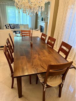 Hard wooden large dining table with 8 chairs