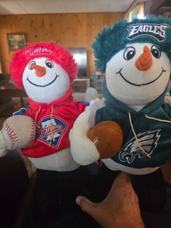 Pair of eagles and phillies plush snowmen