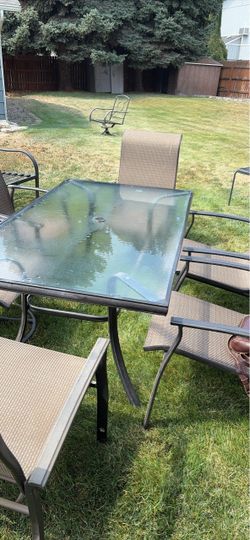 Glass patio table with 6 matching chairs  perfect co diction