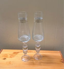 Set of two elegant champagne glasses with gold embellishments.