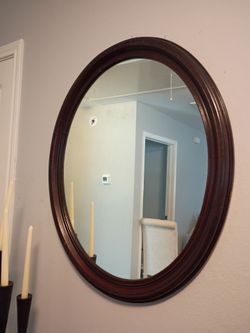 Oval wood trimmed wall mirror