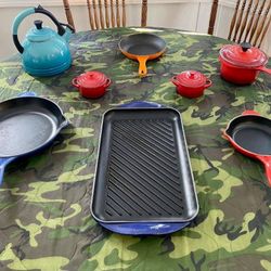 A Grouping Of Le Creuset Skillets Covered Pan And Tea Kettle