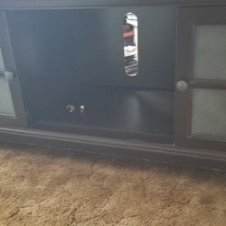 Tv Stand With Adjustable Center Shelf And Adjustable Side Shelf.  Dark Brown color.  2  Cabinets With 2 Doors.