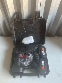 cordless portable 48V pressure washer kit packed in a black plastic case, including a spray gun, two rechargeable batteries, a soap/foam dispenser bot