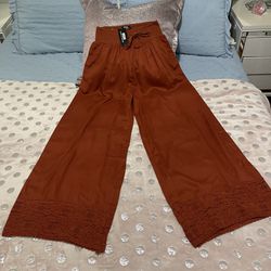 NAOO wide leg pants, with embroidery at the bottom, pockets and elastic waist, 100% rayon, new with tags.size Medium 