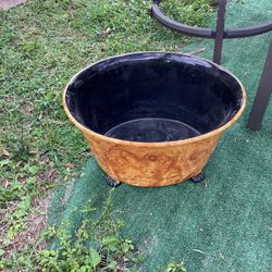 This is a large, footed bowl or planter made of burl wood with a dark, possibly glazed or resin-coated, interior.   Collectible Fine Art Pottery.