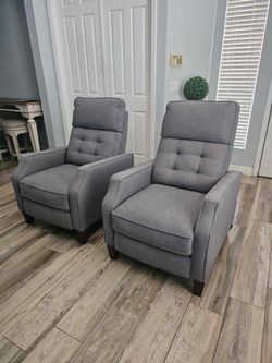 Two beautiful gray push back recliners