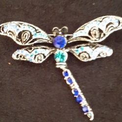 Silver tone dragonfly brooch.