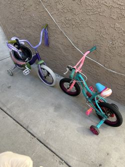 Two Girls Bikes, One With Helmet Girls