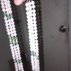 Three strand necklace made out of 14 karat gold beads with Jade and coral beads