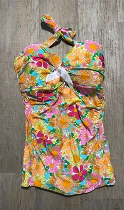 Unique VintageStyle: Retro-inspired one-piece halter swimsuitProduct Details:Design: Vibrant 60s/70s-inspired "Flower Power" floral print in pink, ora