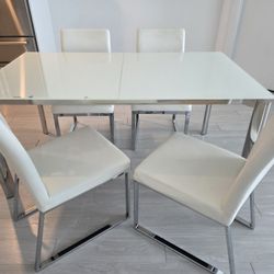 Glass top extendable table with 4 leather chairs Dining set. 