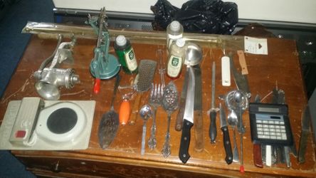 Vintage meat grinder, apple orange peeler, knives candle warmer misc. silverware, kitchen items