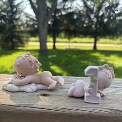 10 Porcelain Bumpkin Figurines Representing Newborn To Age 10