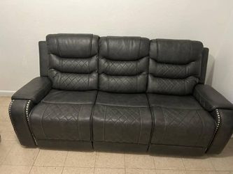 Gray Leather Reclining Sofa with Nailhead Trim