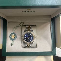 Rolex Blue Face Diamond Bezel Silver and gold. 