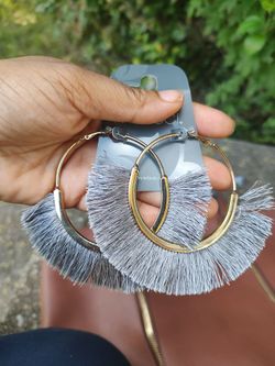 Large gold earrings with grey fringe