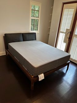 Modern and sturdy queen size IKEA bed frame with customizable headboard pillows