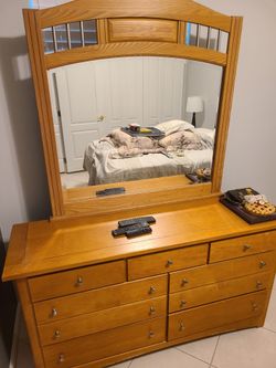 Dresser, mirror headboard and full size bed.