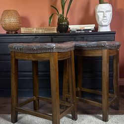 2 faux leather Saddle Bar stools