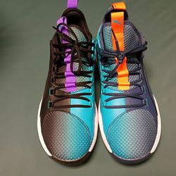 The shoes in the image are the Puma Uproar Hybrid Court ASG Fade sneakers. Featuring teal, purple, navy, and orange colorways. 