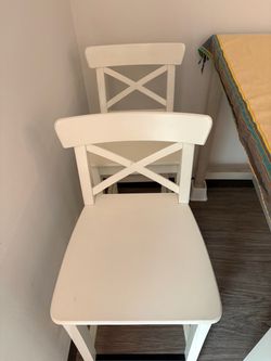 Four bar height white chairs