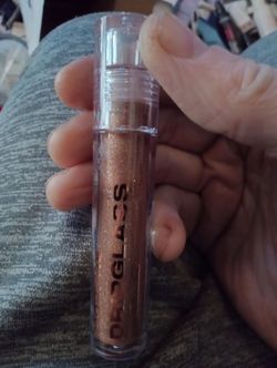 Morphe Dripglass Dazzled High Shimmer Lip Gloss in a bronze shimmer shade.