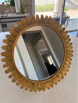 Small vintage tabletop sunburst/starburst vanity mirror with a gold-painted cast metal