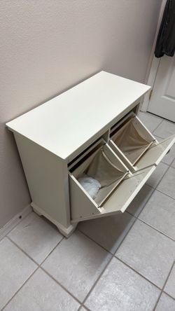Two compartment tilt out linen hamper.