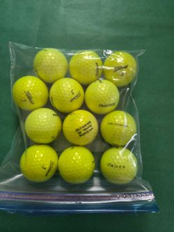 One dozen yellow practice Titliest golf balls , matching numbers, like new