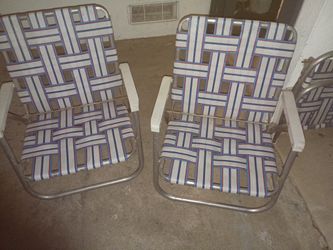 This is a set of 3 vintage Sunbeam folding aluminum lawn chairs with a red, white, and blue webbed design