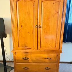 Large, Solid Wood Armoire/Dressed with two arched-top doors, shelves, and 2 wide drawers