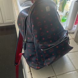 fairly new mcm backpack navy blue with red logo