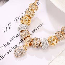 Pandora style gold charms bracelet 