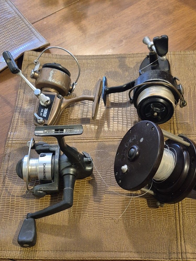 Four fishing reels. head browning zebco and mitchell