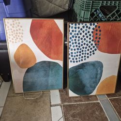 three framed abstract canvas wall art pieces featuring geometric shapes in terracotta, blue, and orange colors. 