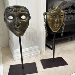 Pair of vintage brass theater masks on metal stand