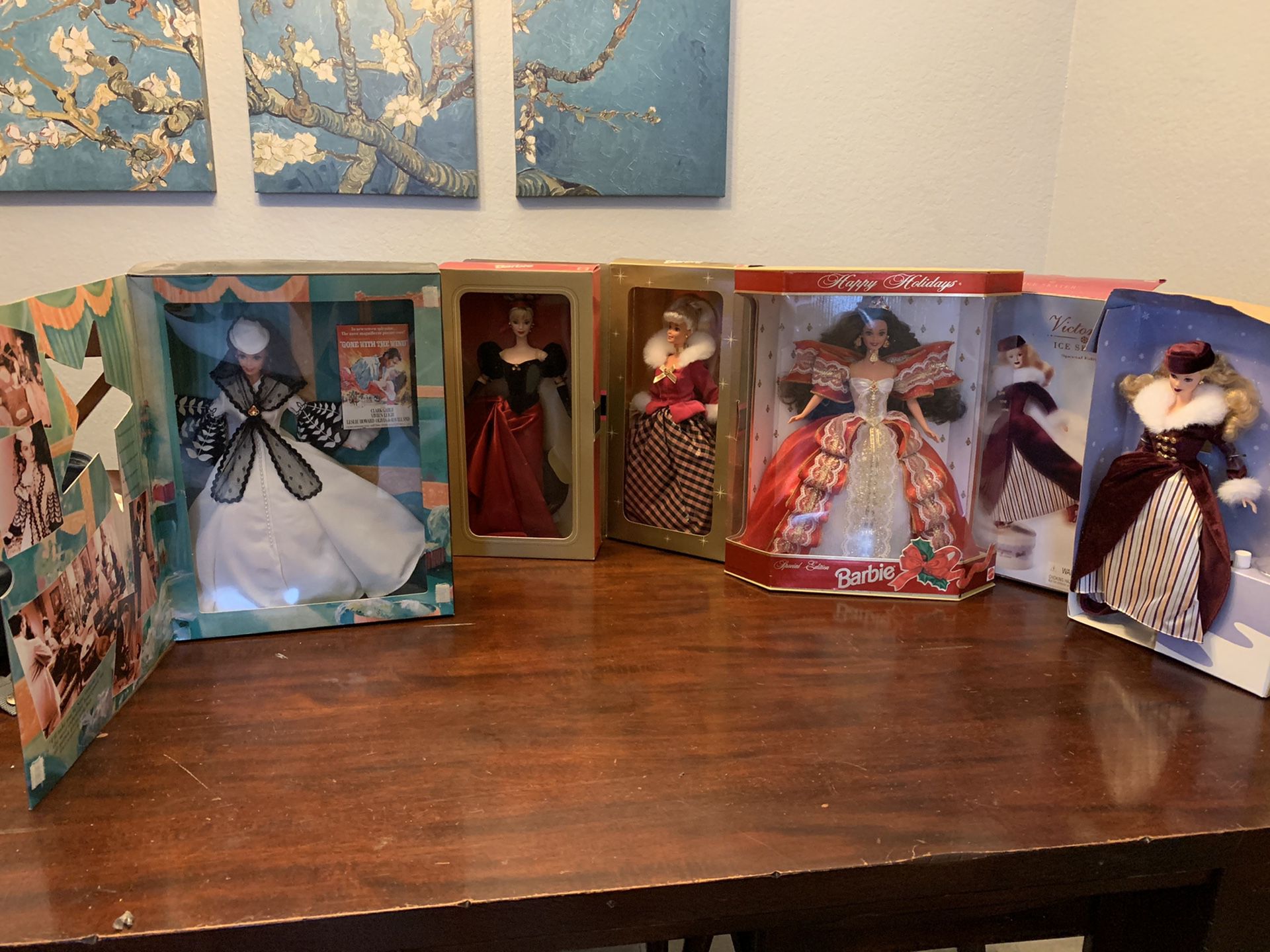 Five collectible Barbie dolls in original packaging.