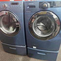 Samsung front load washer and electric dryer on pedestals
