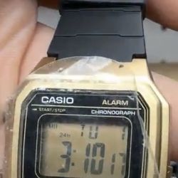 Casio  Watch Digital with a gold-tone case and black resin strap