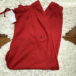 This is a pair of men's Jordan Essentials Fleece Pants in University Red Large on tag