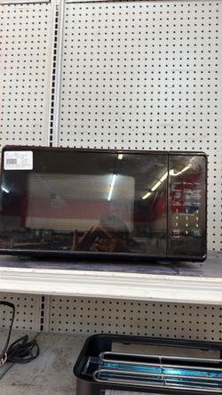 Small black rusted microwave