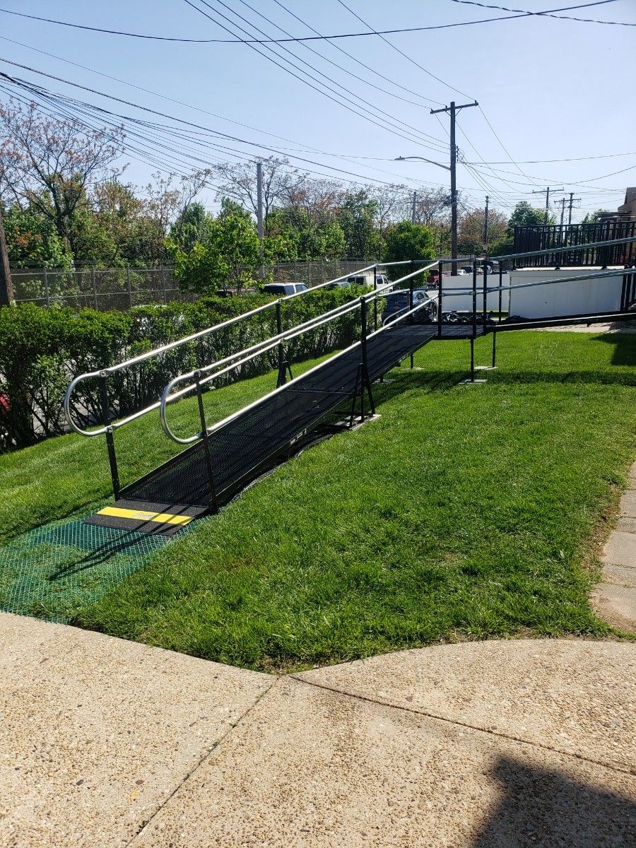 Heavy duty wheelchair ramp with platforms and handrails approximately 57 feet