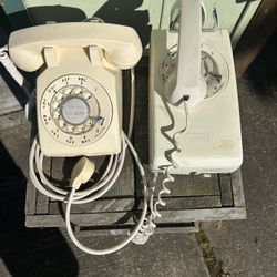 Two vintage ivory color telephones in good condition. One is a desk phone. The other is a wall mount Phone.   Both still work.   $40 each or both for 