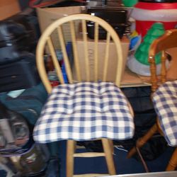 3 bar stools with cushions 2 like 1 different.