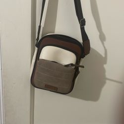 The bag in the image is an Aldo Krill260 Beige & Brown Color Block Medium Cross Body Bag