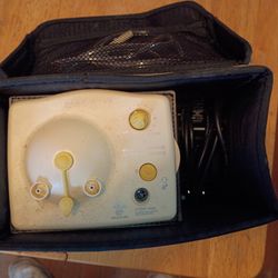 Medela Pump In Style Advanced breast pump motor unit housed in its carrying case.