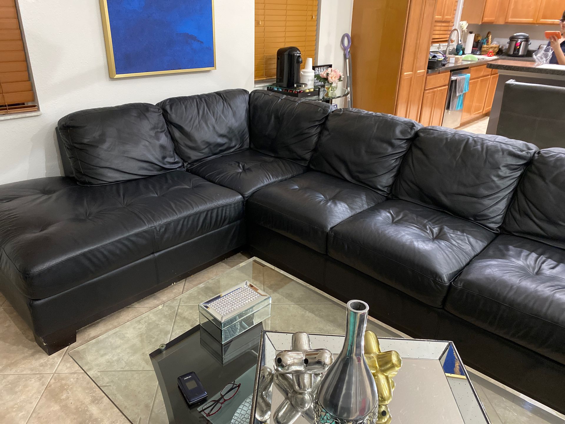 Large black sectional couch with ottoman