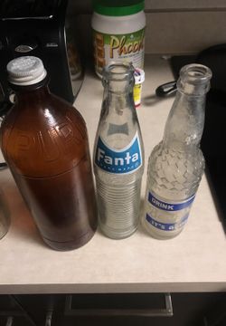 Old collectible bottles from the 50s the brown one is an OP Rex bottle with a lid on it $15