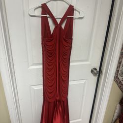 red evening gown with a ruched bodice and a flared hem.